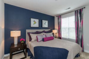 white bed in front of blue wall