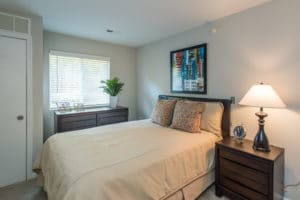 main bedroom with tan bedspread