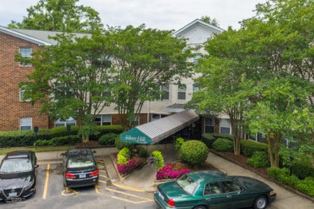 Exterior of a senior apartment community with green awning