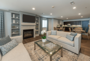 main room at the muse at town center with white couches and fireplace